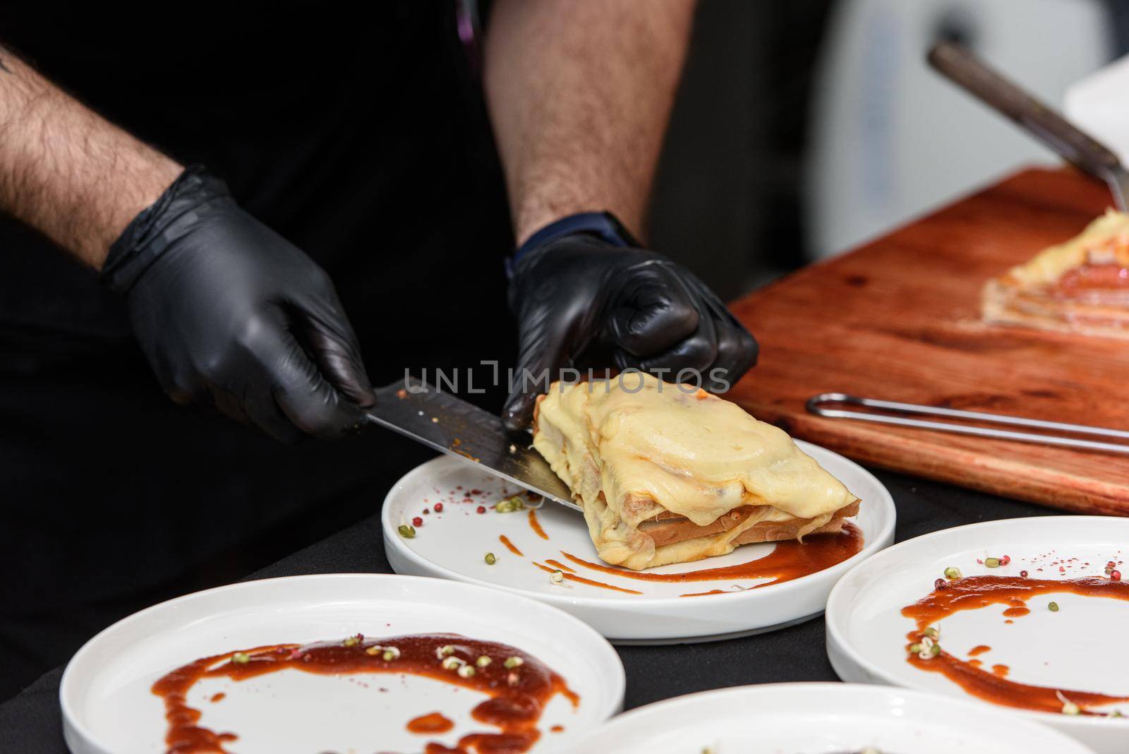 Francesinha, traditional Portuguese sandwich originally from Porto. National cuisine concept. the chef prepares a dish at restaurant.