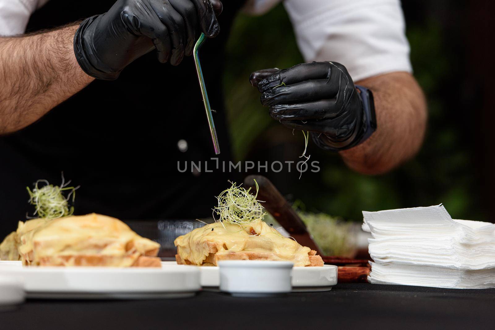 Francesinha, traditional Portuguese sandwich originally from Porto. National cuisine concept. the chef prepares a dish at restaurant.