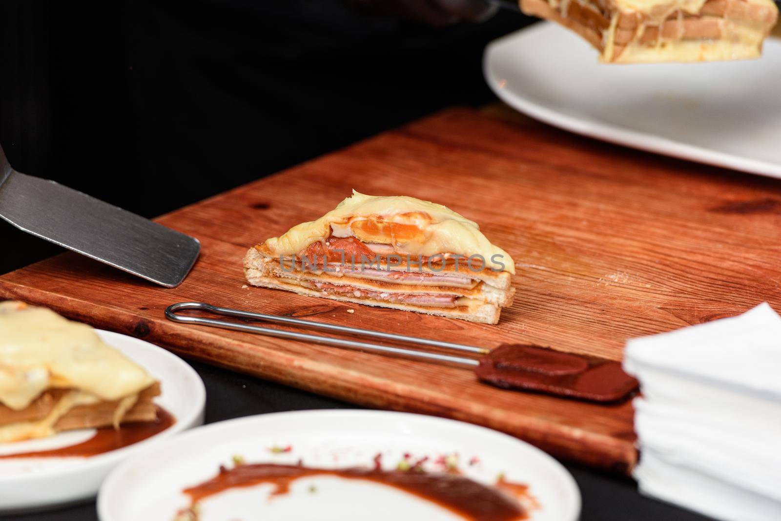 Francesinha, traditional Portuguese sandwich originally from Porto. National cuisine concept. the chef prepares a dish at restaurant.