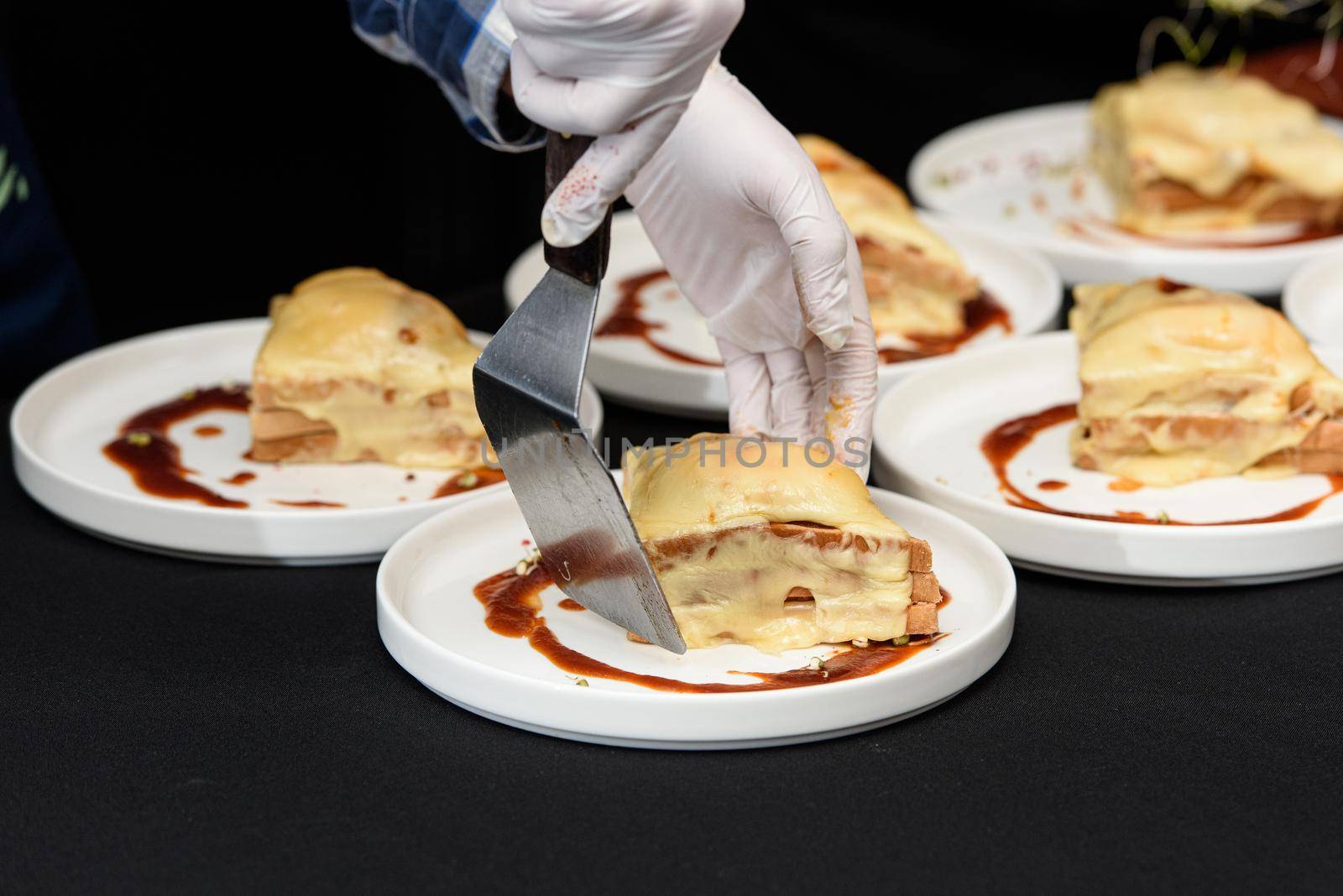 Francesinha, traditional Portuguese sandwich originally from Porto. National cuisine concept. the chef prepares a dish at restaurant by Ashtray25