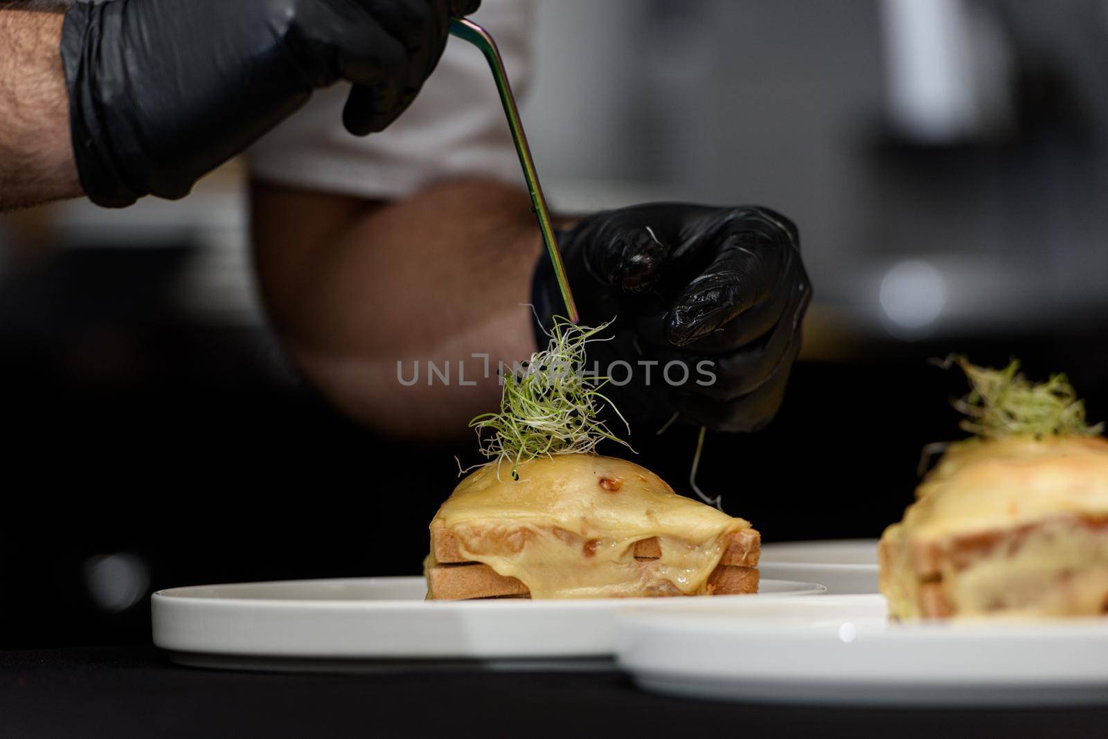 Francesinha, traditional Portuguese sandwich originally from Porto. National cuisine concept. the chef prepares a dish at restaurant.