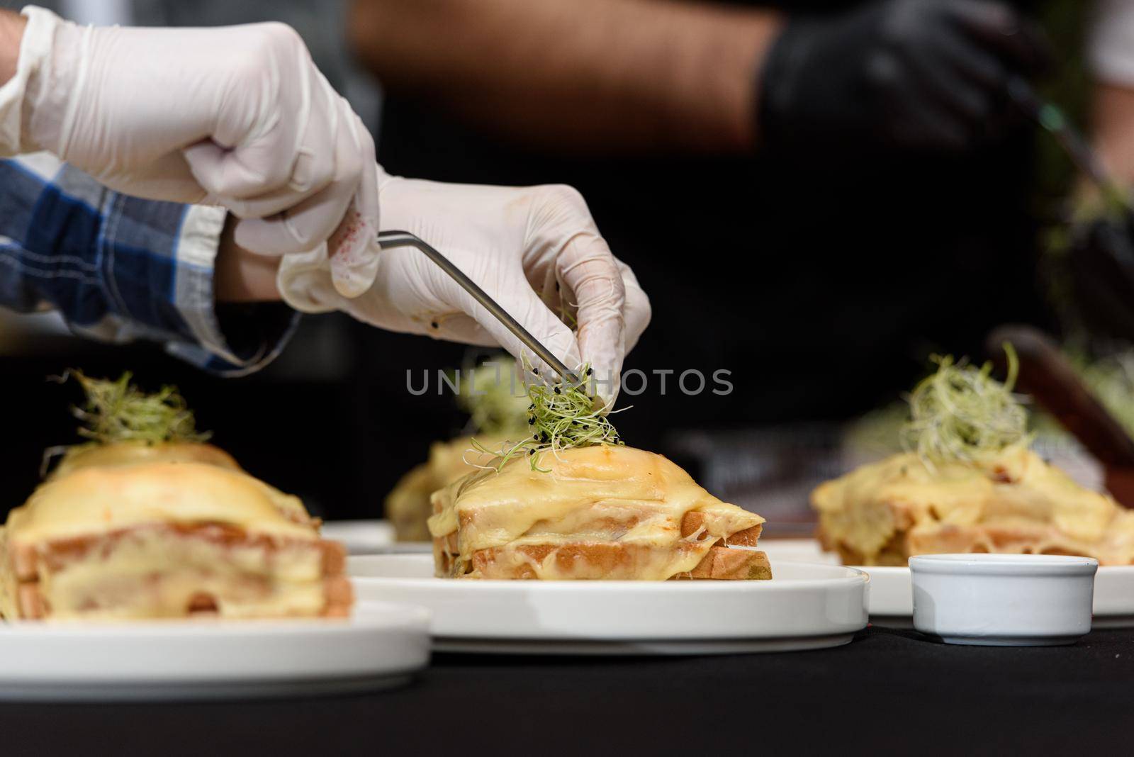 Francesinha, traditional Portuguese sandwich originally from Porto. National cuisine concept. the chef prepares a dish at restaurant.