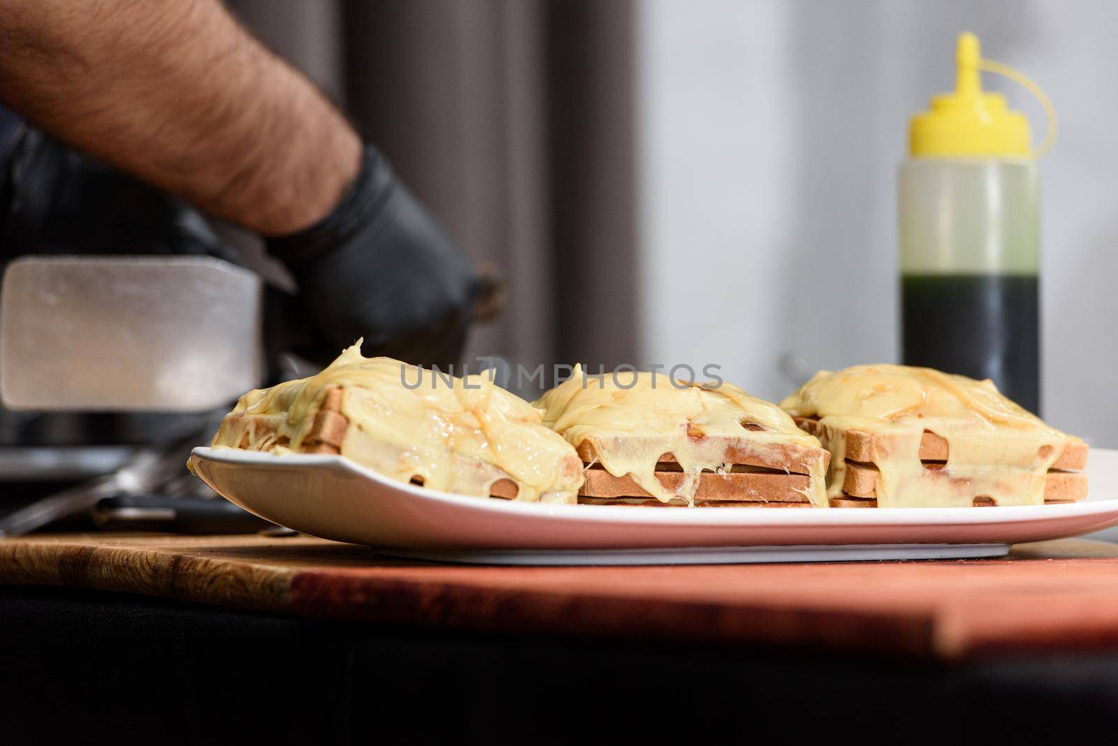 Francesinha, traditional Portuguese sandwich originally from Porto. National cuisine concept. the chef prepares a dish at restaurant.