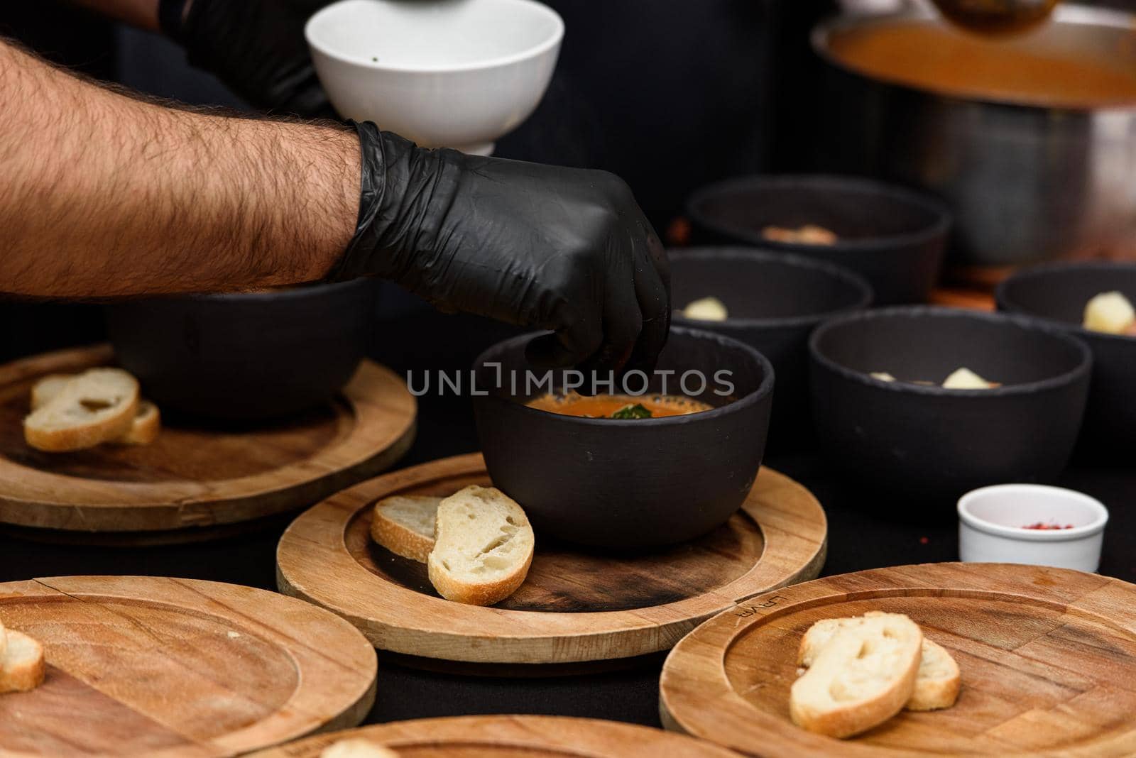 cooking process of Suquet de Peix soup with potatoes, herbs and fish with the addition of picada close-up in a saucepan on the table. by Ashtray25