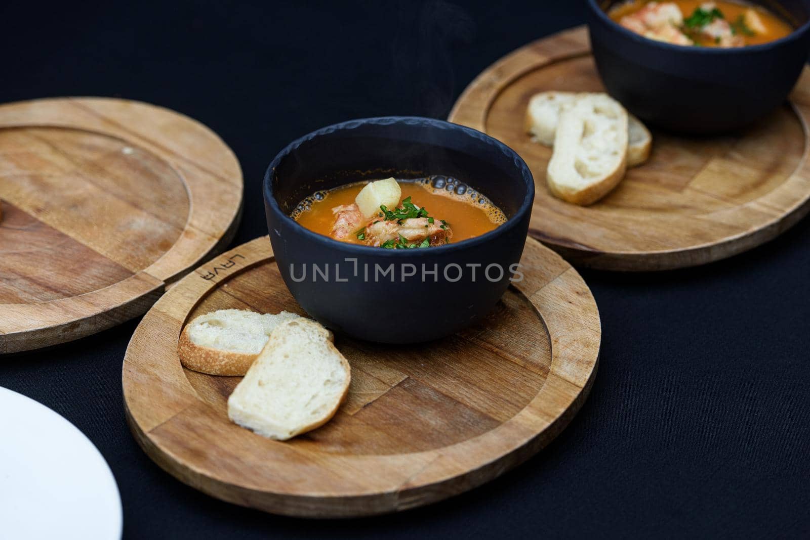 Seafood spicy soup with potatoes, shrimps, herbs and fish from a picad closeup in a pan served with toast. horizontal by Ashtray25