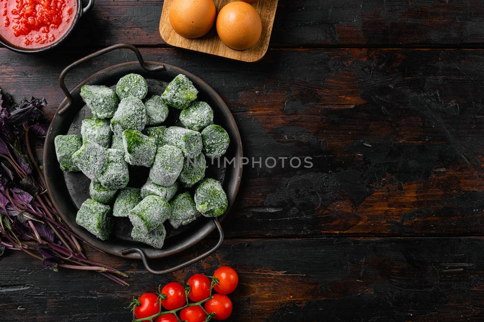 Frozen spinach set, on old dark wooden table background, top view flat lay, with copy space for text