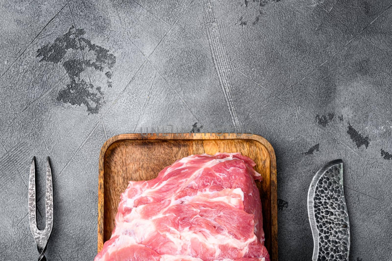 Raw meat, on gray stone table background, top view flat lay, with copy space for text by Ilianesolenyi