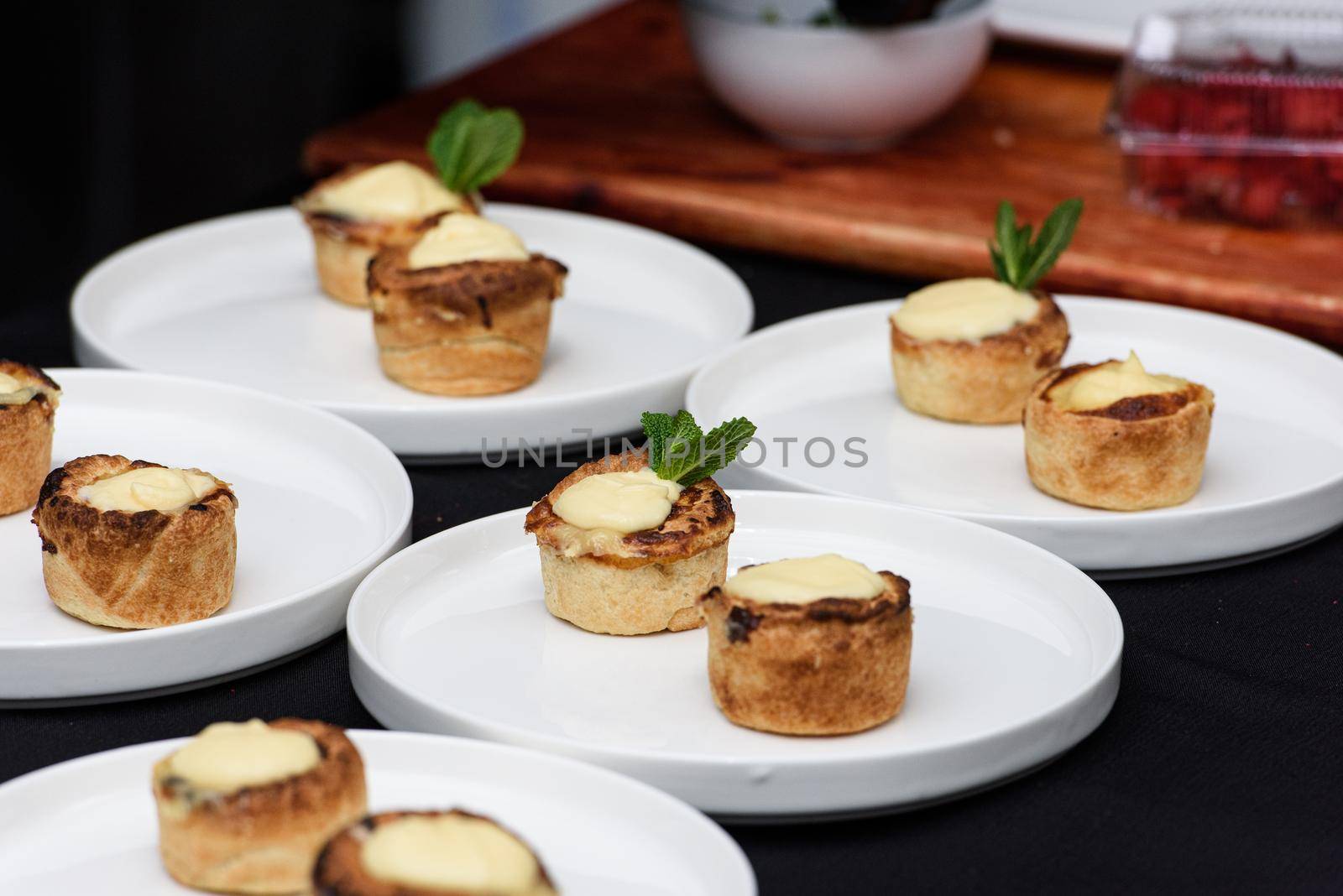 Typical Portuguese custard pies Pastel de Nata or Pastel de Belem. traditional portuguese pastry. On a black tablecloth.