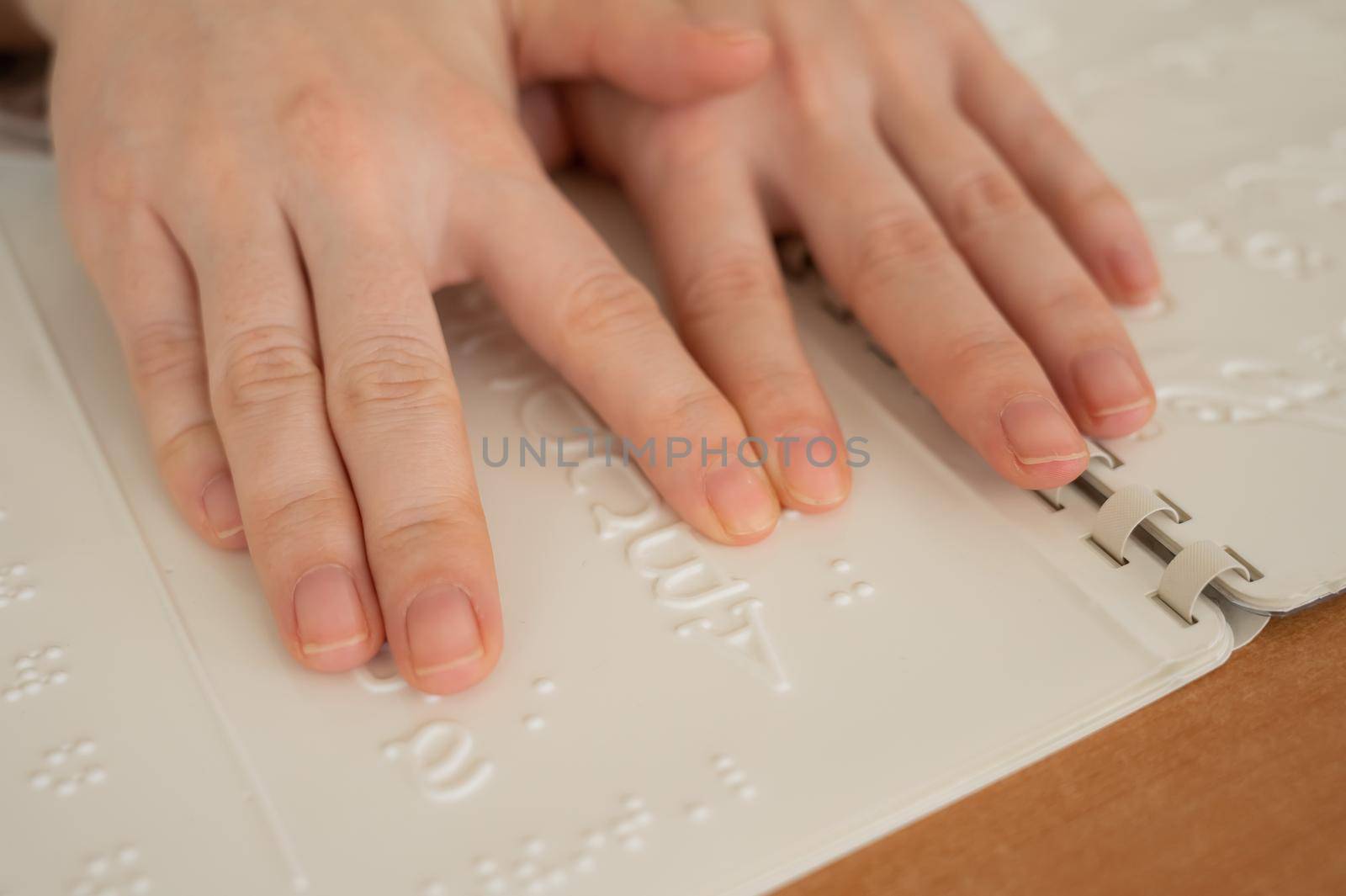A woman learns the Braille alphabet using a decoder. by mrwed54
