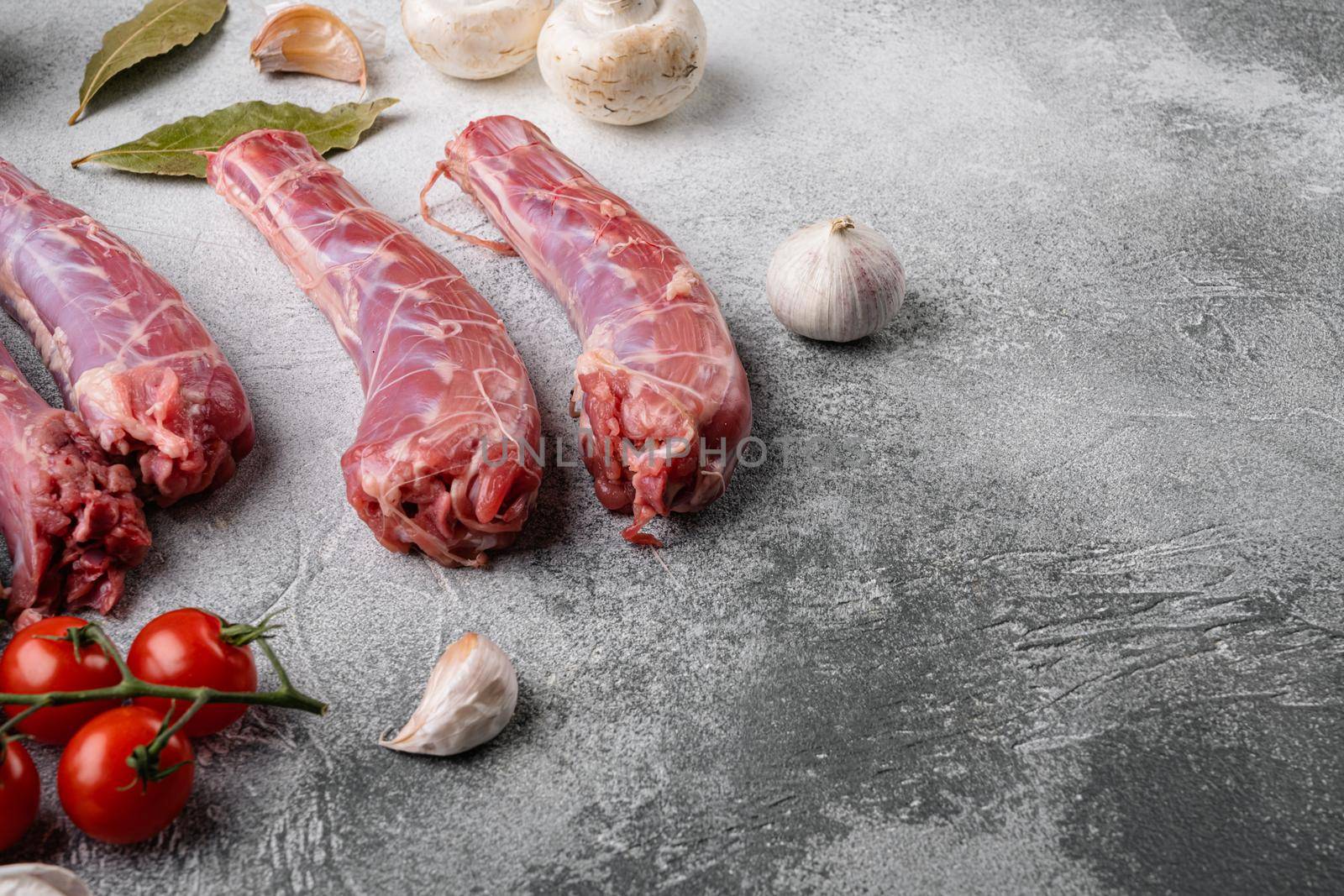 Raw turkey neck without skin set, on gray stone table background, with copy space for text