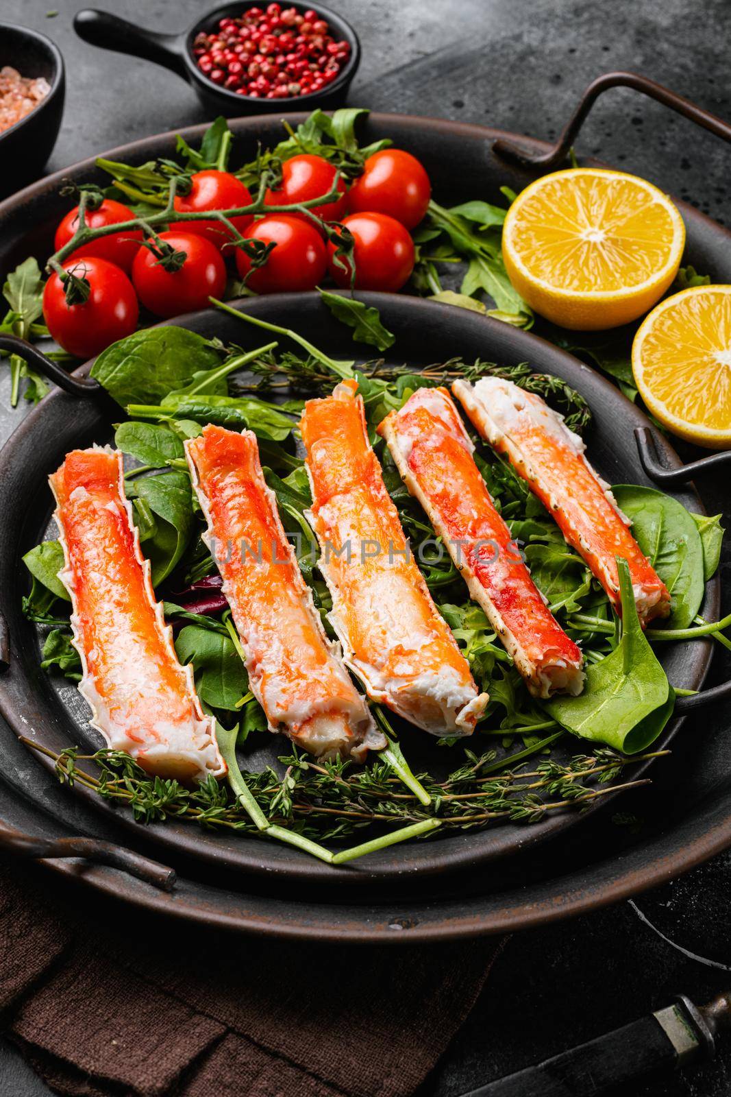 Cooked crab legs set, on black dark stone table background