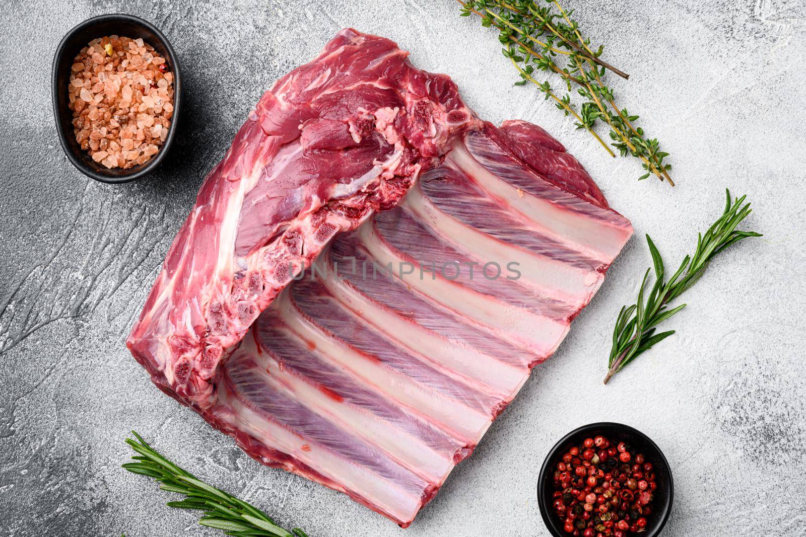 Rack of lamb , raw meat with bone set, on gray stone table background, top view flat lay