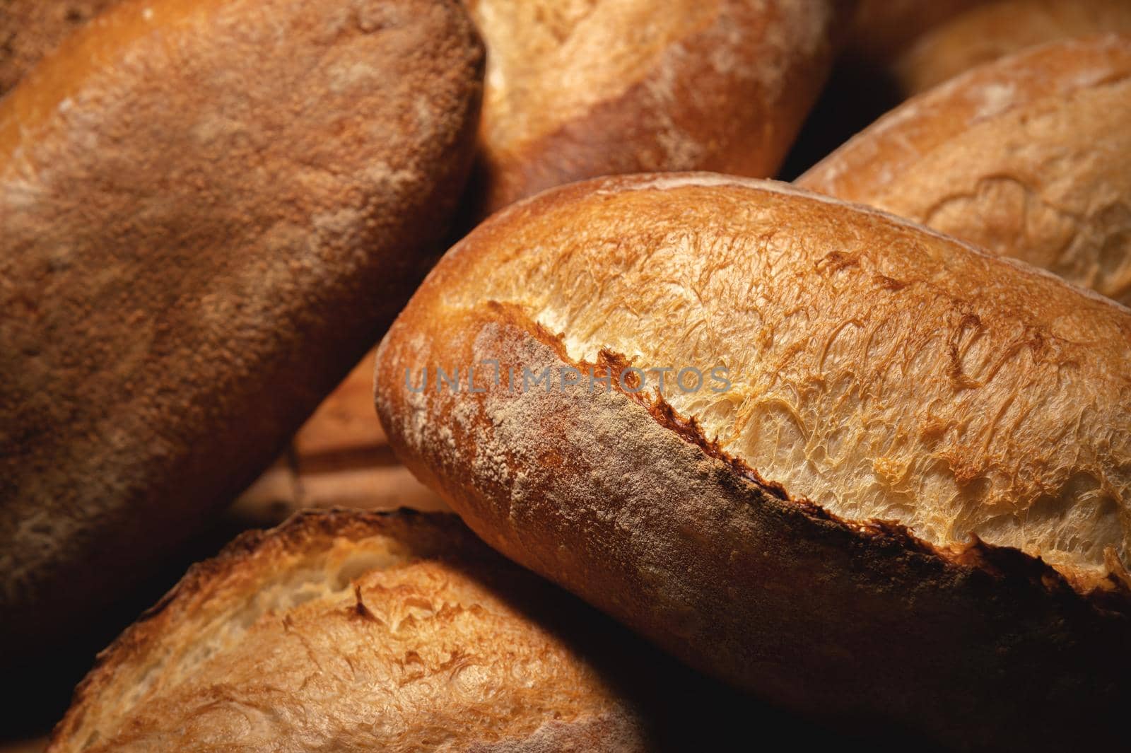 Sourdough bread close-up. Freshly baked round bread with golden crust on bakery shelves. The context of a German bakery with a rustic assortment of bread