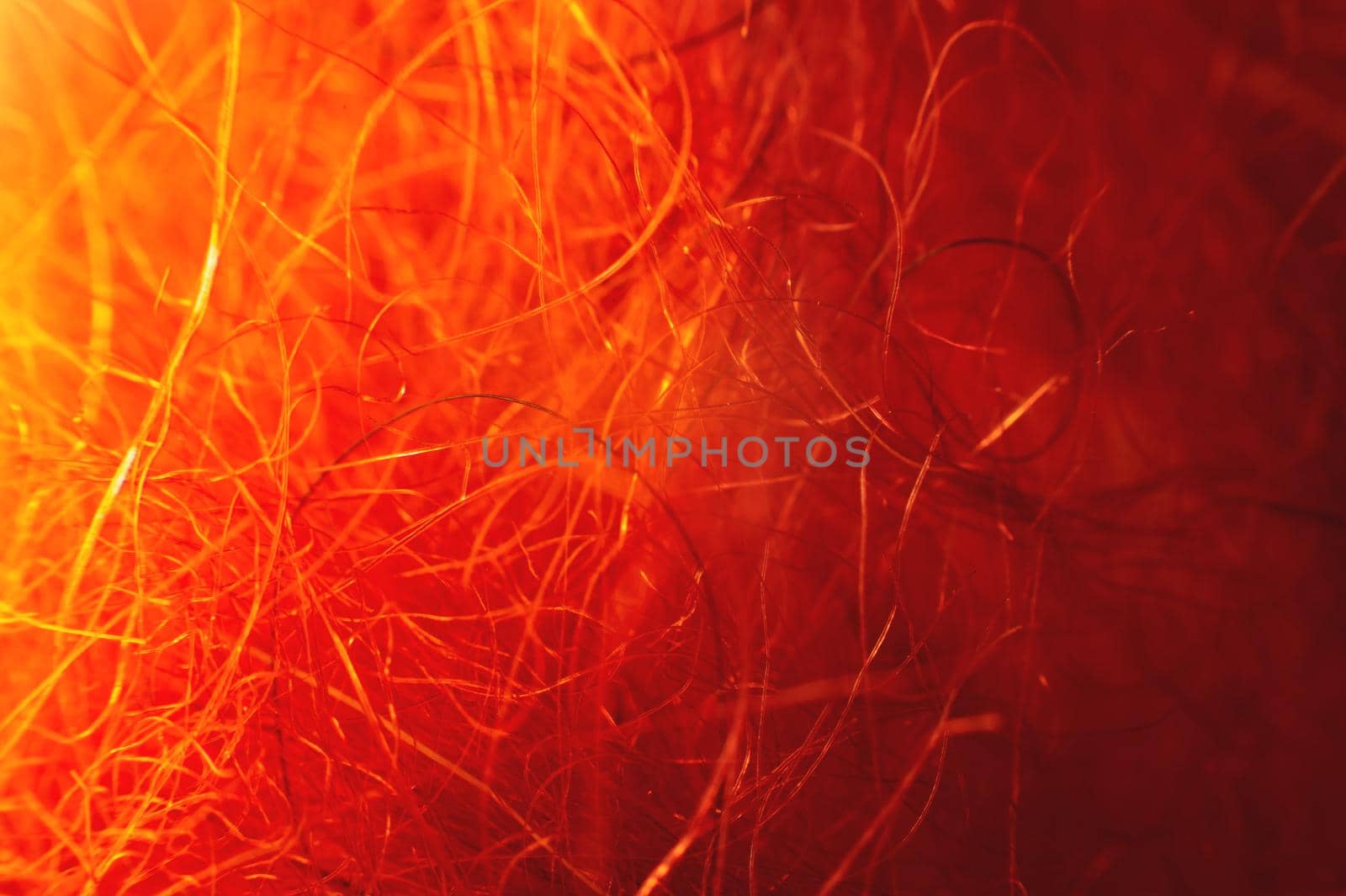 Macro photo. Close-up abstract textile fiber red-orange color extreme macro in shallow depth of field. Abstract background.