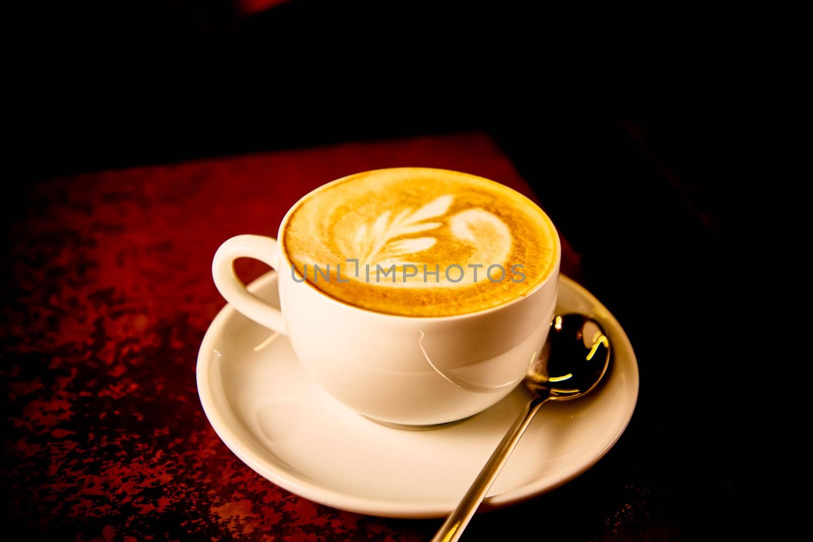 A Cup of cappuccino coffee on a dark background by Milanchikov