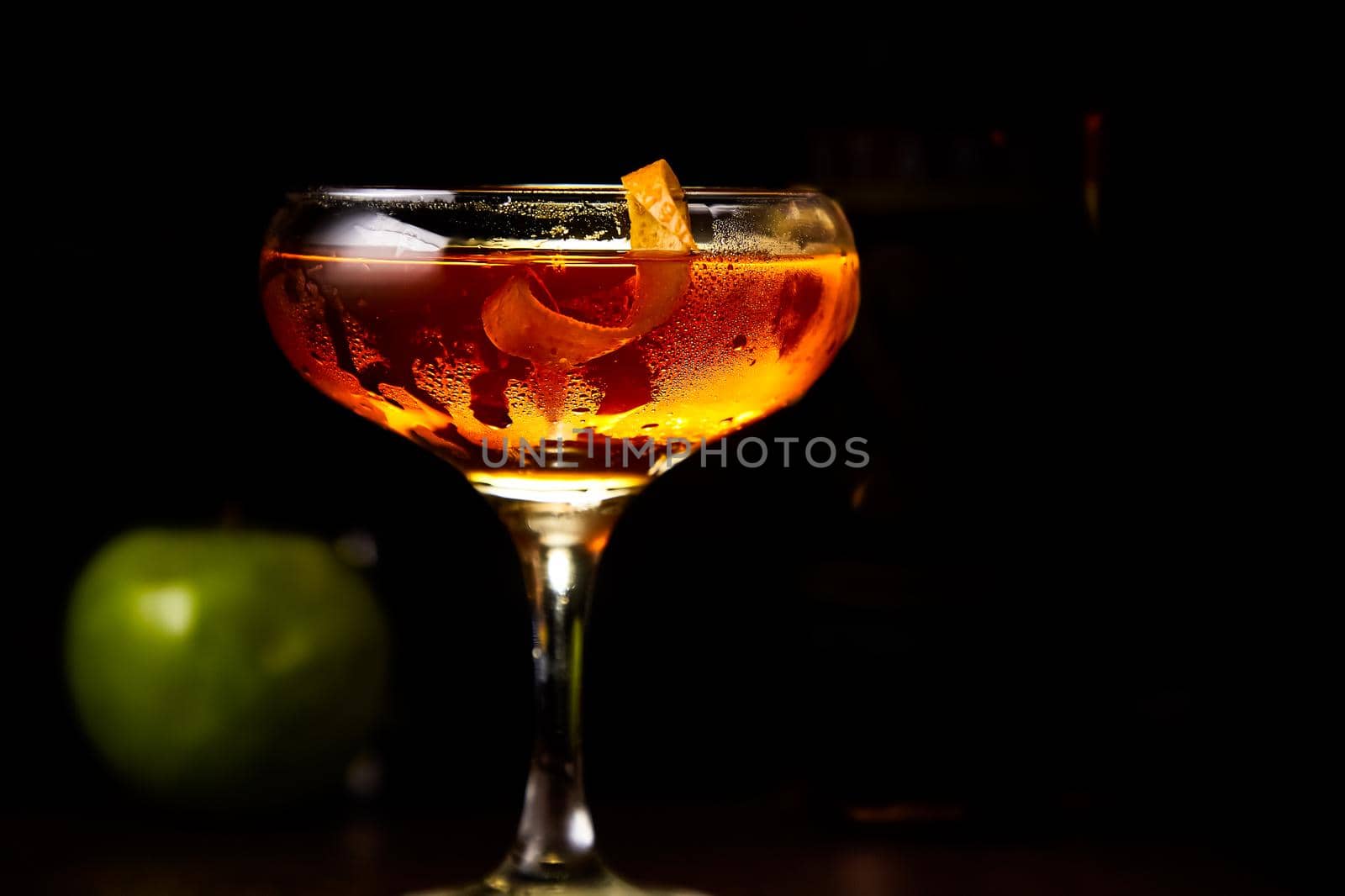 Red cocktail with lemon slice and Apple by Milanchikov