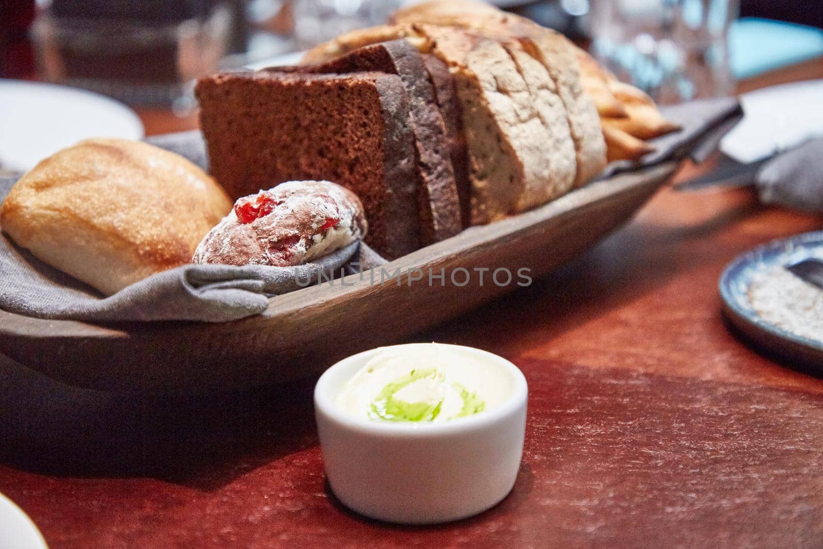 Basket with different bread on the table in the restaurant