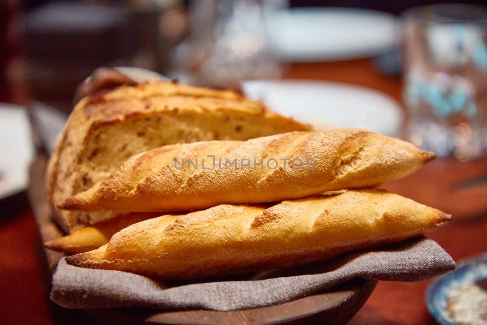 Basket with different bread on the table in the restaurant