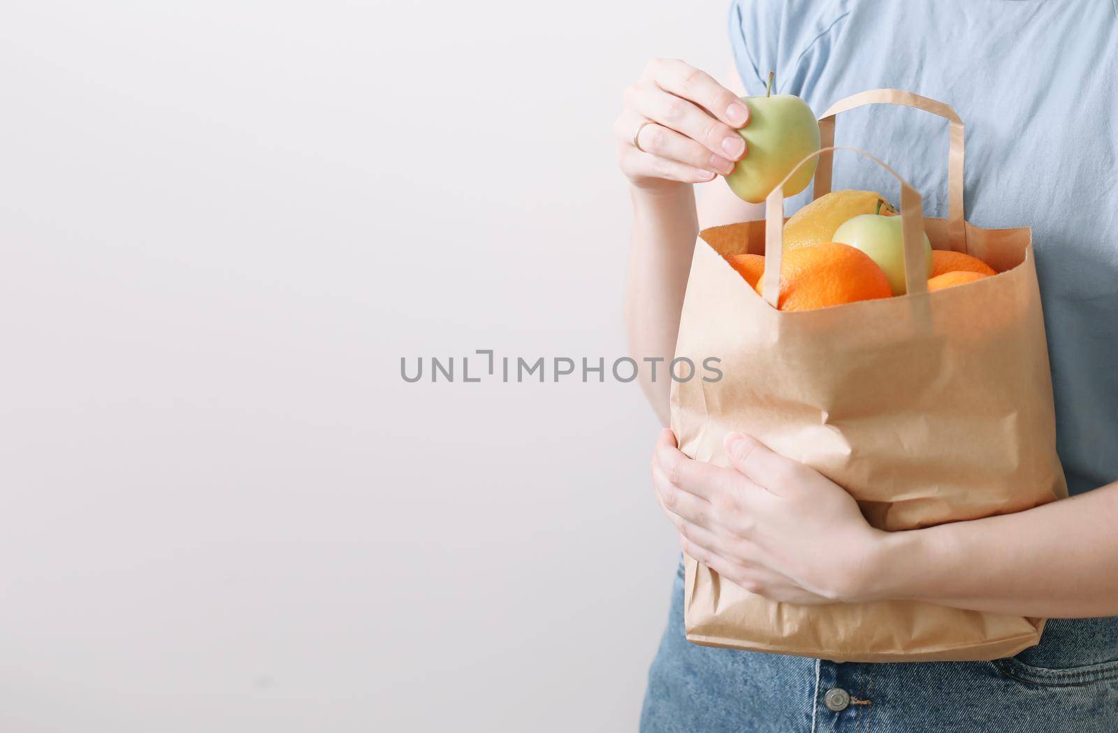 Delivery healthy food background. Vegan vegetarian food in paper bag vegetables and fruits on white, copy space, banner.Grocery shopping food supermarket and clean vegan eating concept.