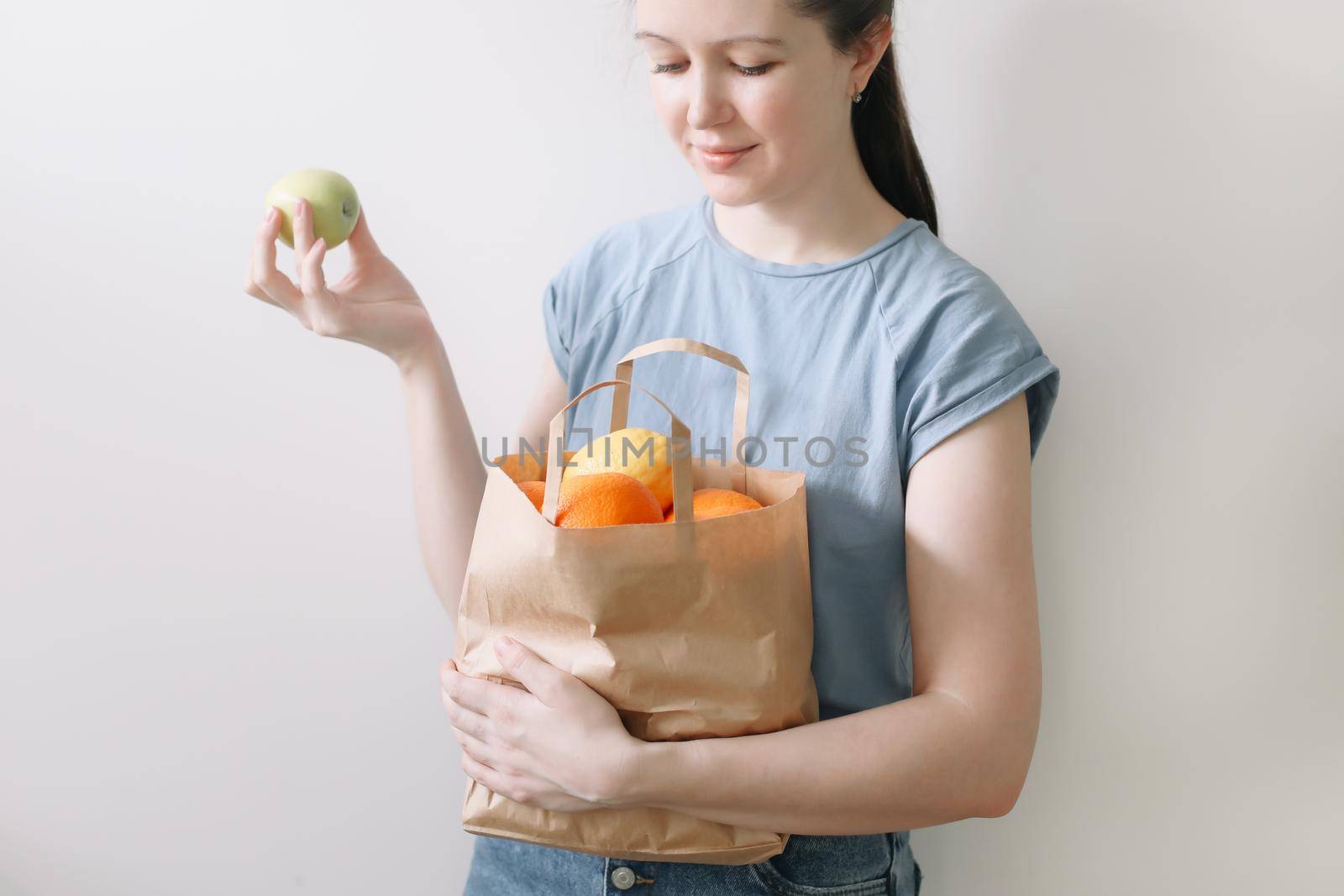 Delivery healthy food background. Vegan vegetarian food in paper bag vegetables and fruits on white, copy space, banner.Grocery shopping food supermarket and clean vegan eating concept.