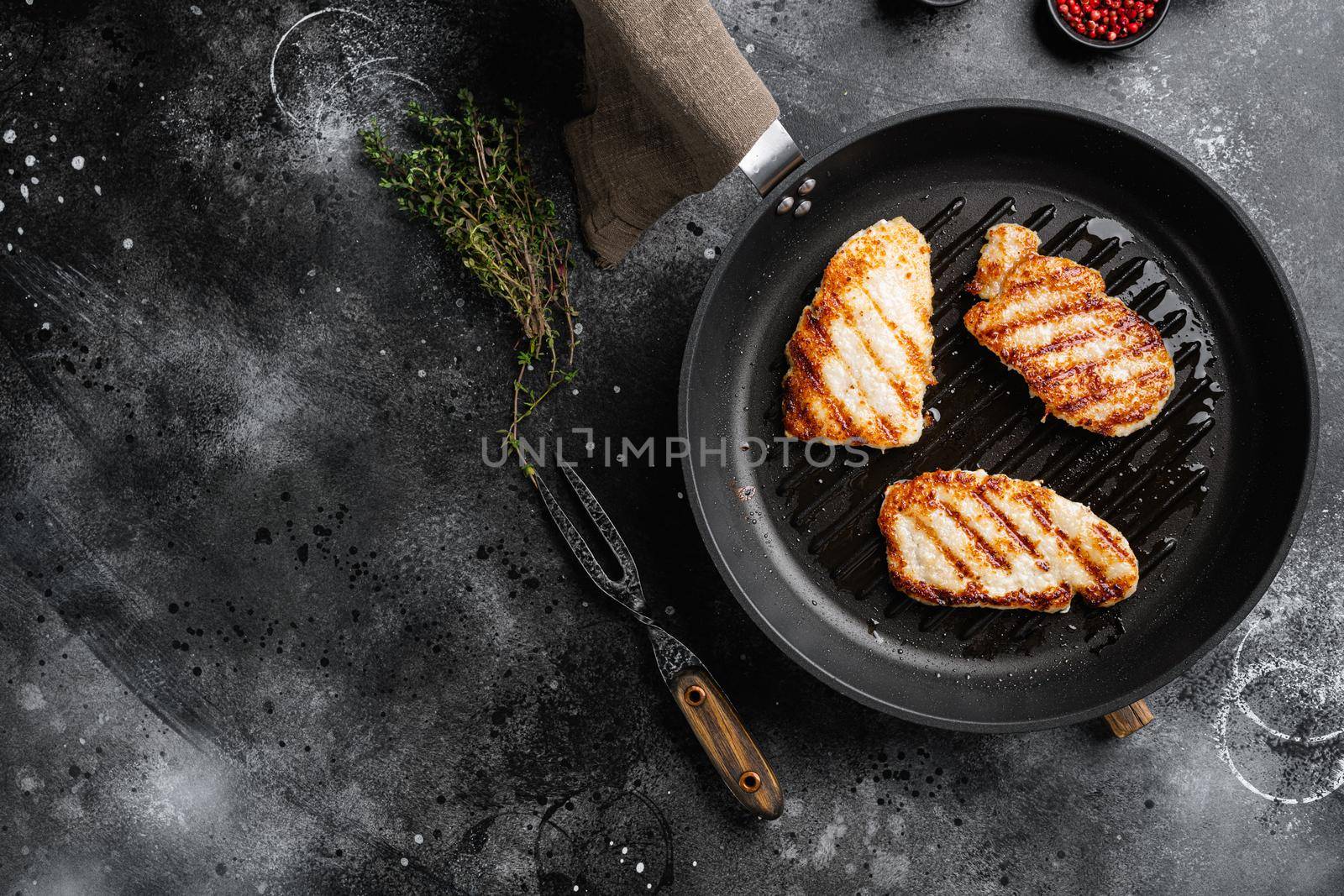 Ready to eat chicken schnitzel set, on black dark stone table background, top view flat lay, with copy space for text by Ilianesolenyi
