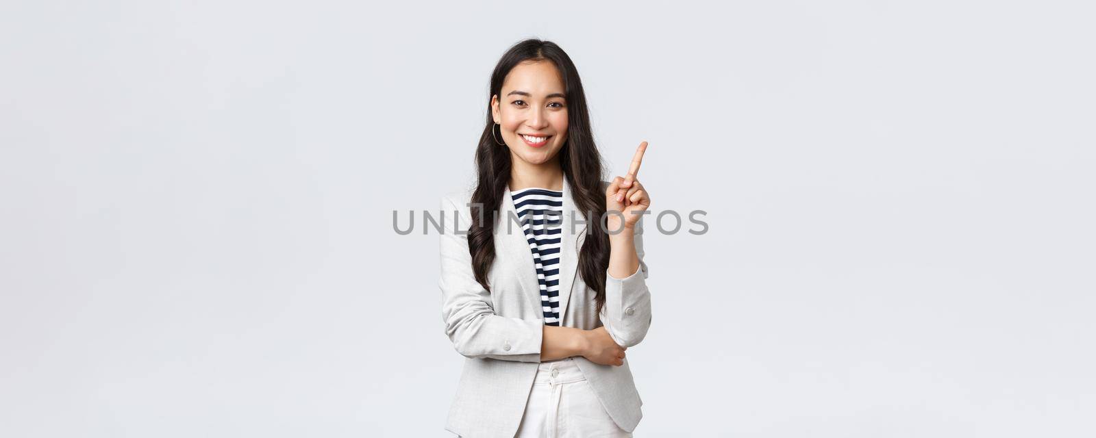 Business, finance and employment, female successful entrepreneurs concept. Successful female businesswoman, asian real estate broker pointing finger, showing number one and smiling.