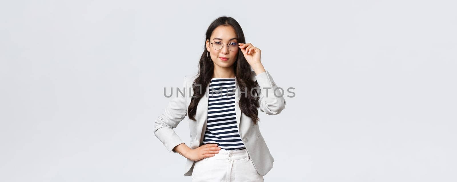 Business, finance and employment, female successful entrepreneurs concept. Confident businesswoman in glasses and white suit ready for meeting, smiling pleased, standing determined.