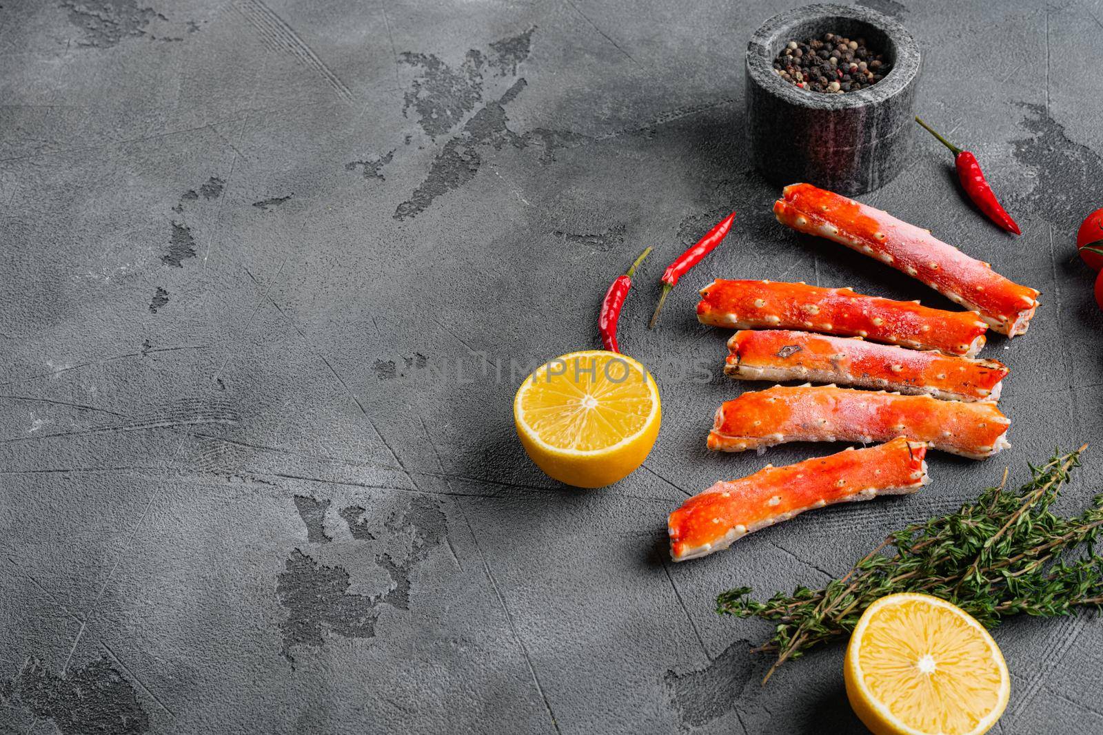 Crab leg meat in a sheel set, on gray stone table background, with copy space for text