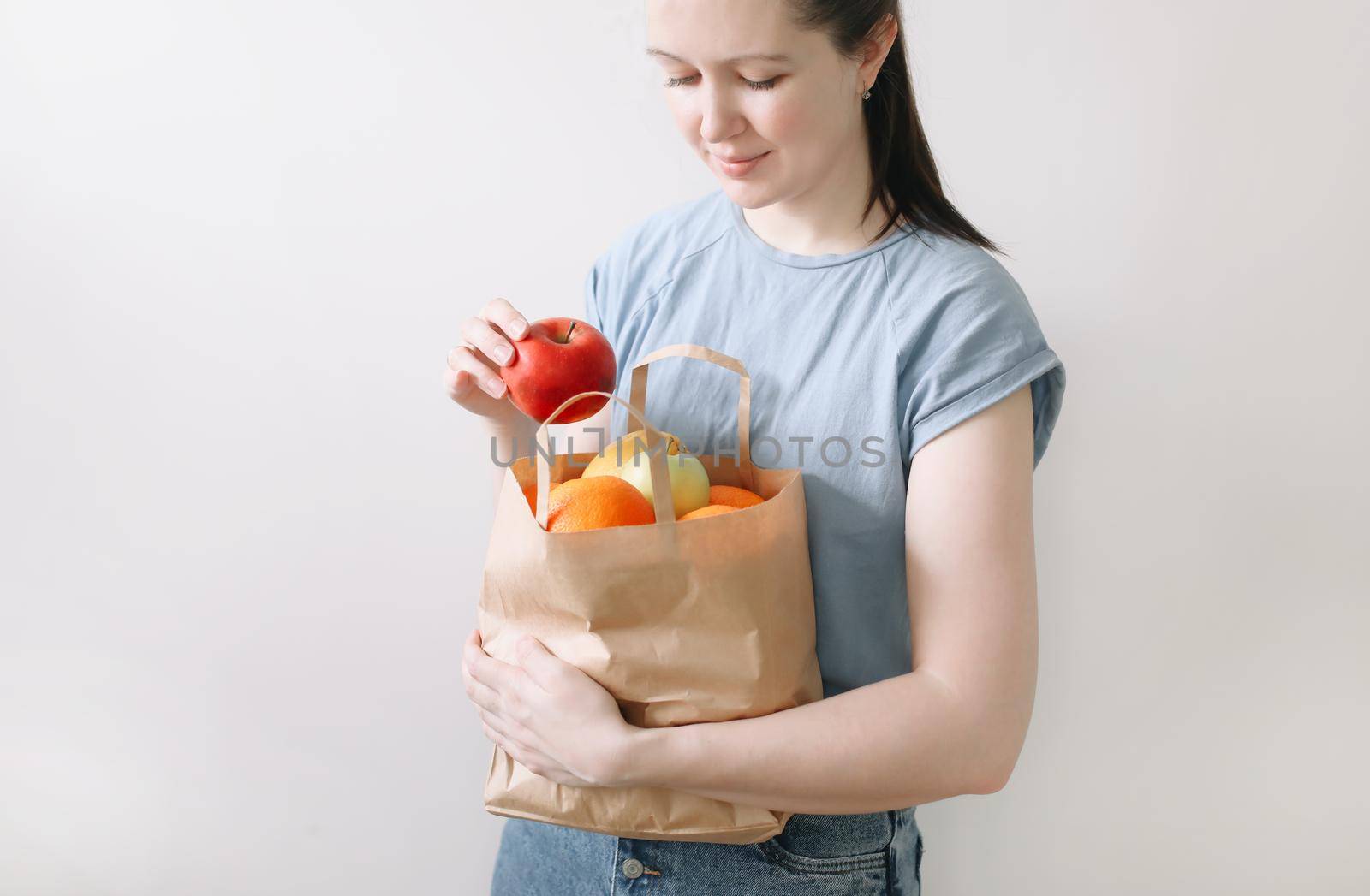 Delivery healthy food background. Vegan vegetarian food in paper bag vegetables and fruits on white, copy space, banner.Grocery shopping food supermarket and clean vegan eating concept.