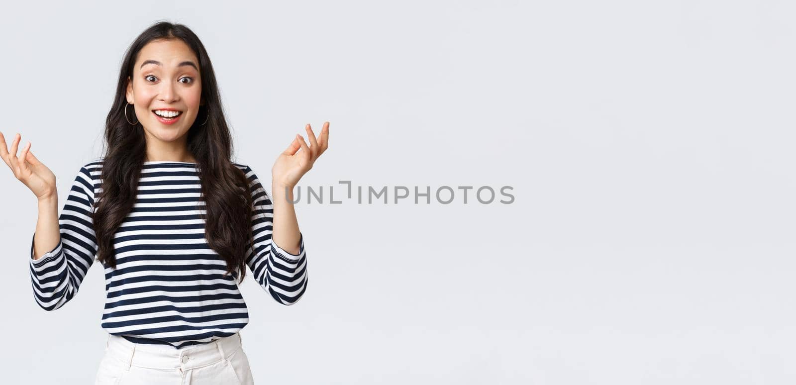 Lifestyle, beauty and fashion, people emotions concept. Surprised and amazed happy smiling asian woman find out perfect news, raise hands up astonished, congratulating or praising friend by Benzoix