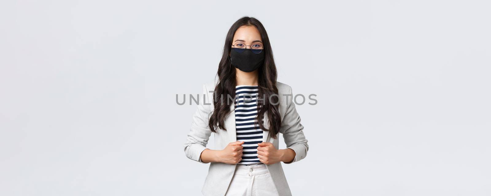 Business, finance and employment, covid-19 preventing virus and social distancing concept. Professional cheerful businesswoman wearing protective mask during office meeting to prevent disease spread.