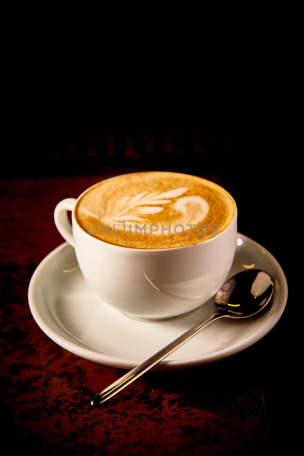 A Cup of cappuccino coffee on a dark background by Milanchikov