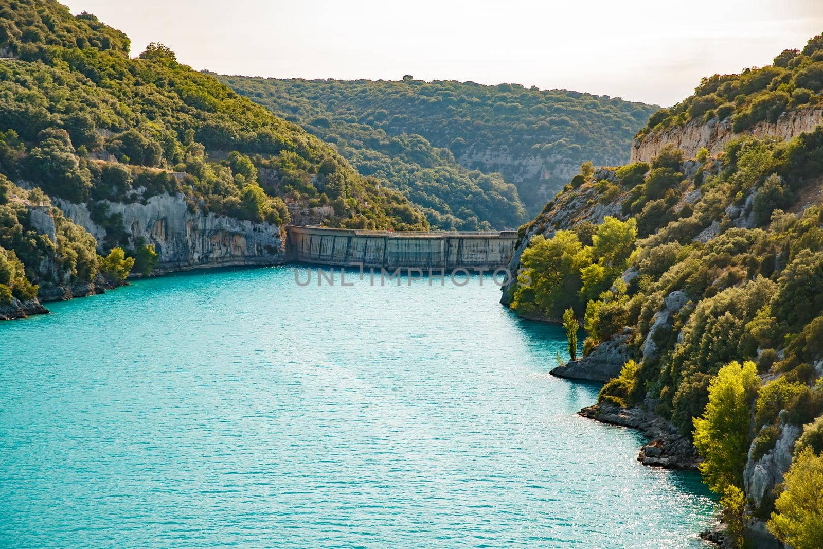Power plant dam in France, Provence, lake Saint Cross, gorge Verdone, azure water of the lake and slopes of mountains on a background. High quality photo
