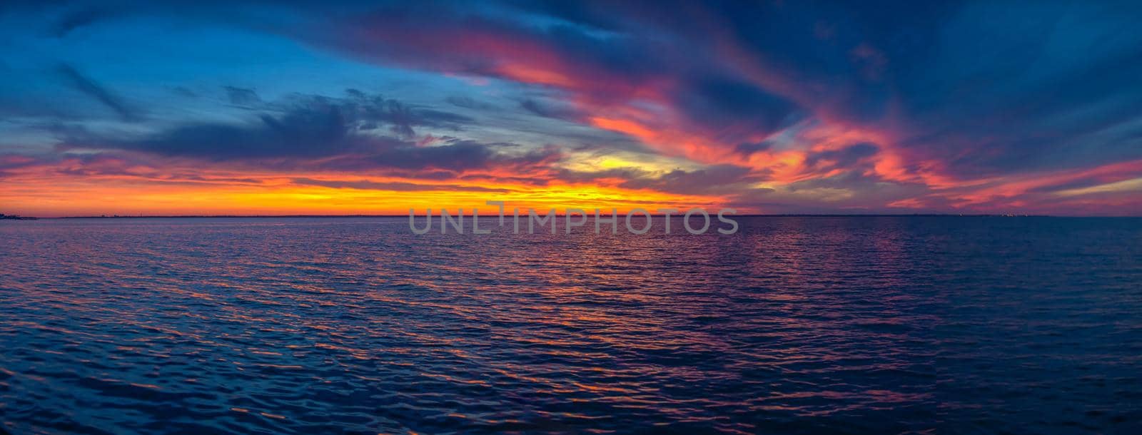 Beautiful sunset over the water surface on a summer evening