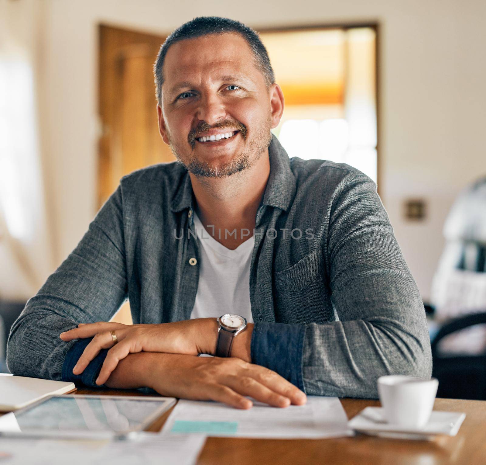 The man with the family plan. Cropped shot of a man planning his family budget at home. by YuriArcurs