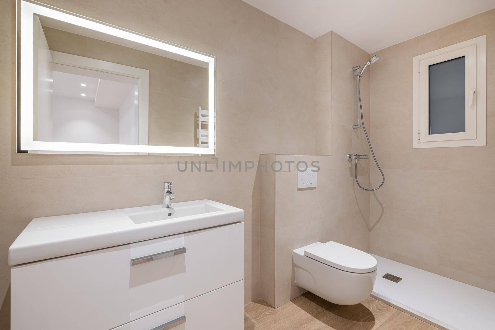 Modern bathroom with beige tiles, shower, toilet and rectangular large mirror with lighting by apavlin