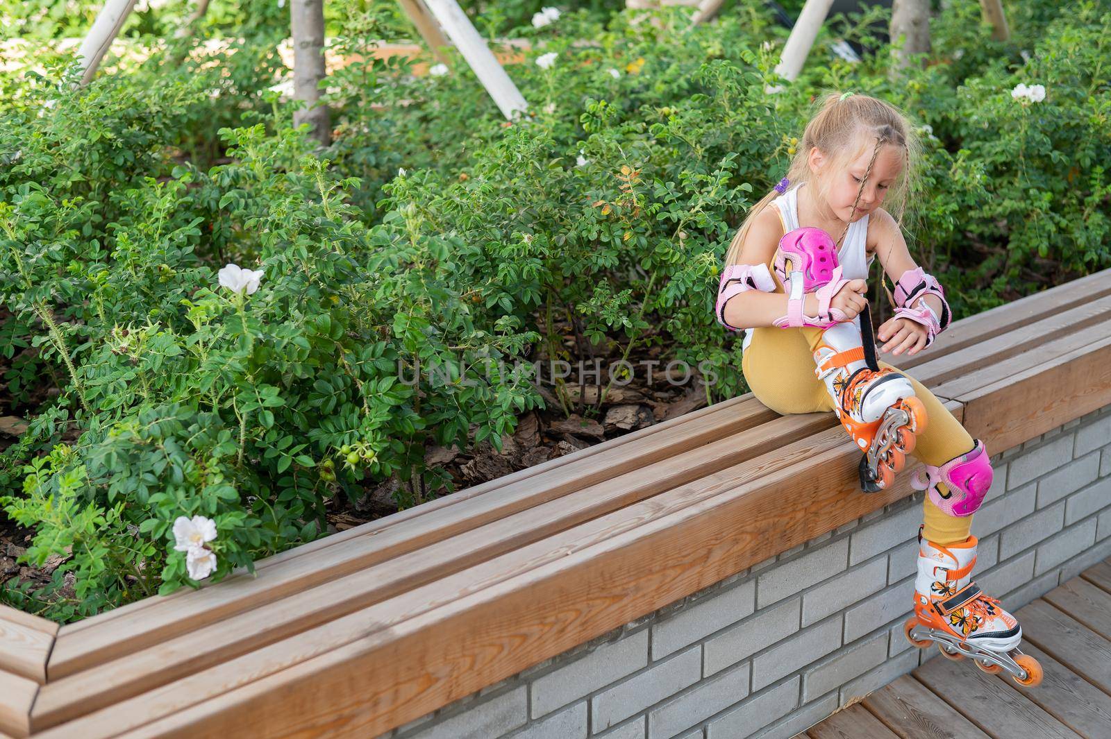 Little girl learns to roller skate outdoors. by mrwed54