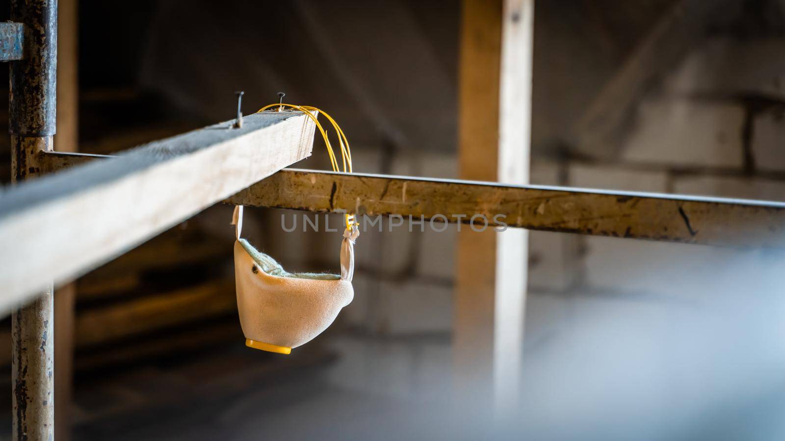 Construction respirator U-2K half mask hanging on scaffolding close-up