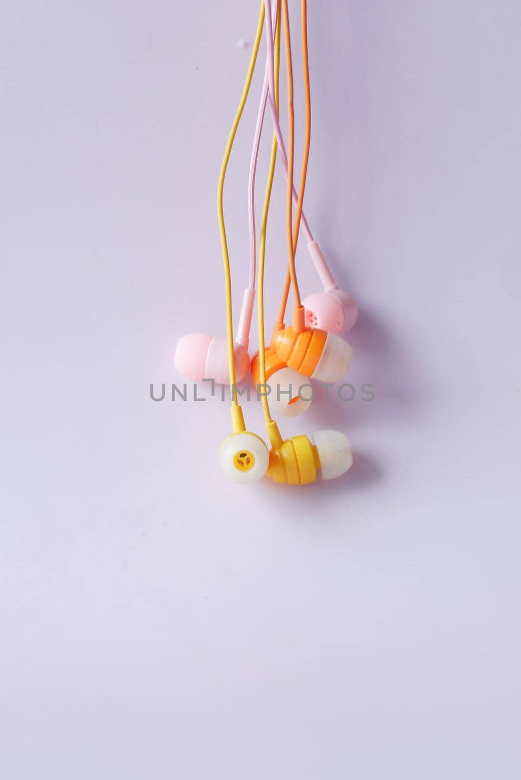 close up of colorful earphone on white background by towfiq007