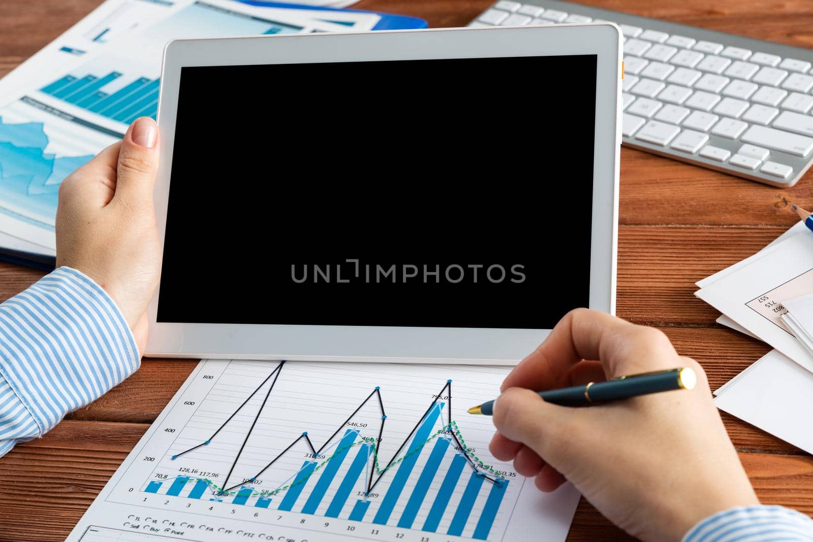 close-up, female hands with tablet. Business woman working at the table in the office