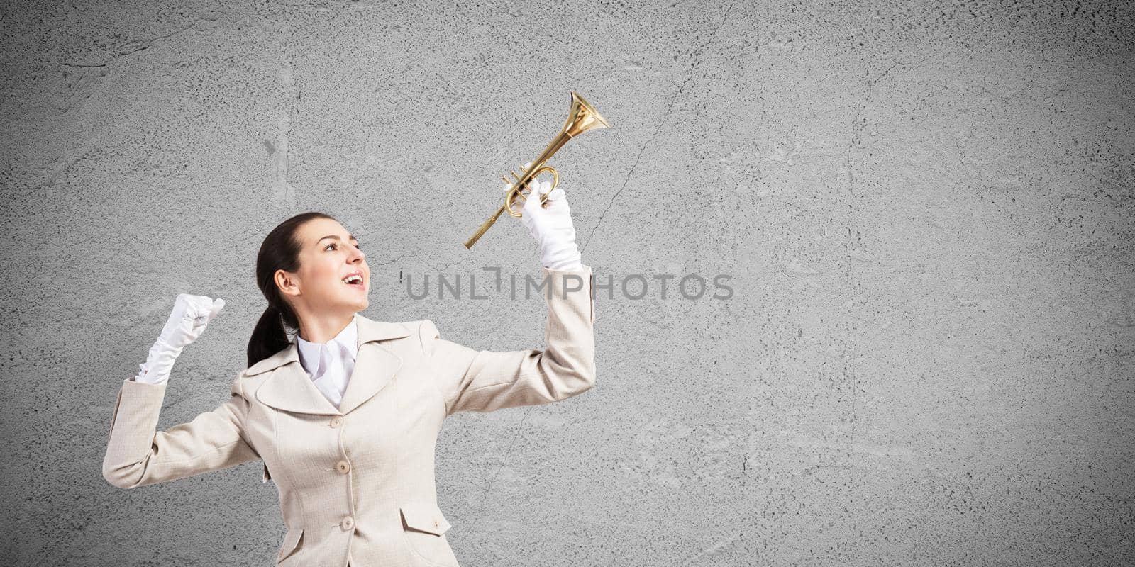 Beautiful woman holding trumpet brass overhead by adam121