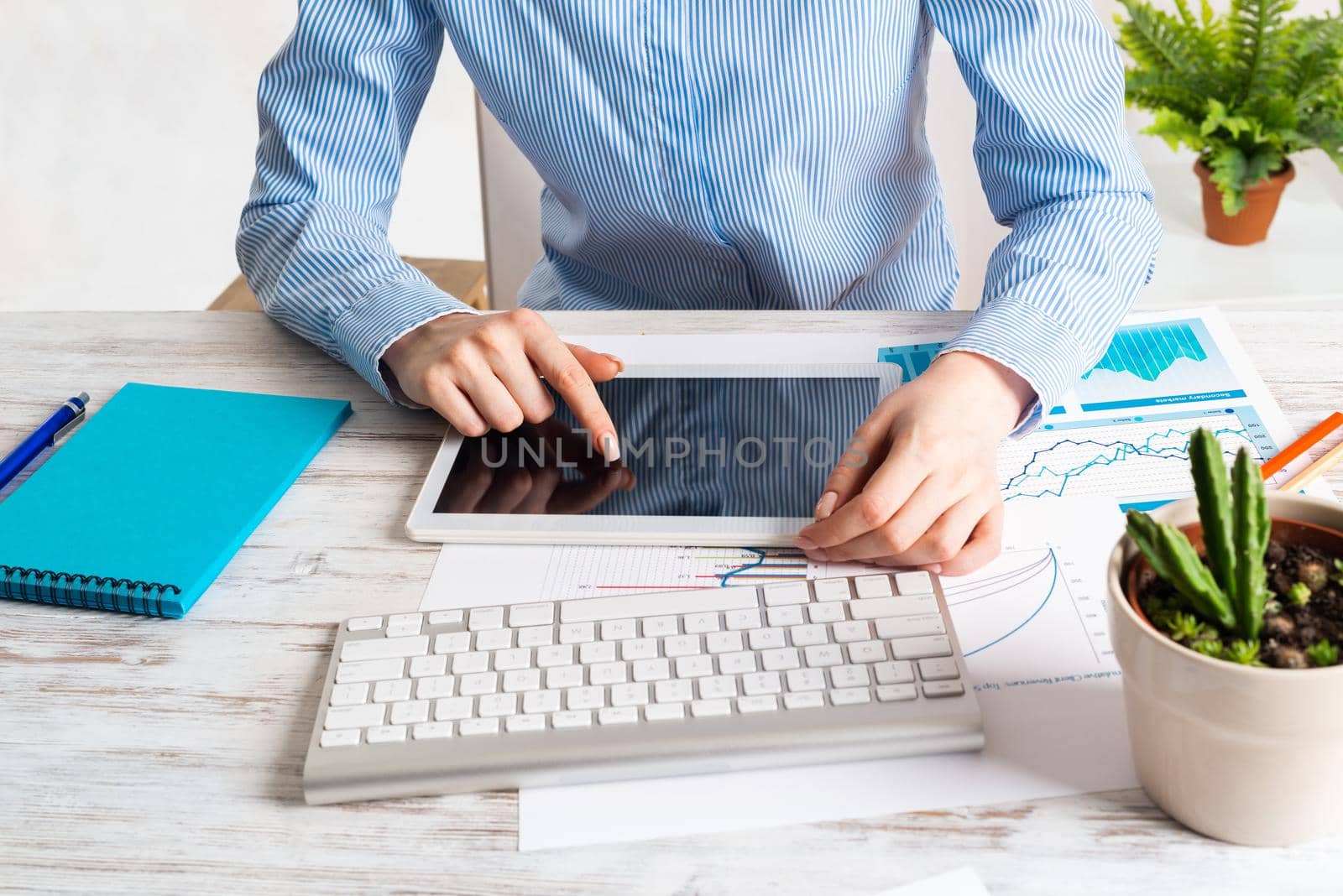Manager using tablet computer with blank screen. Close up woman hand pointing on touchscreen. Strategy planning and banking. Analyst on workplace at wooden desk. Business accounting and management.