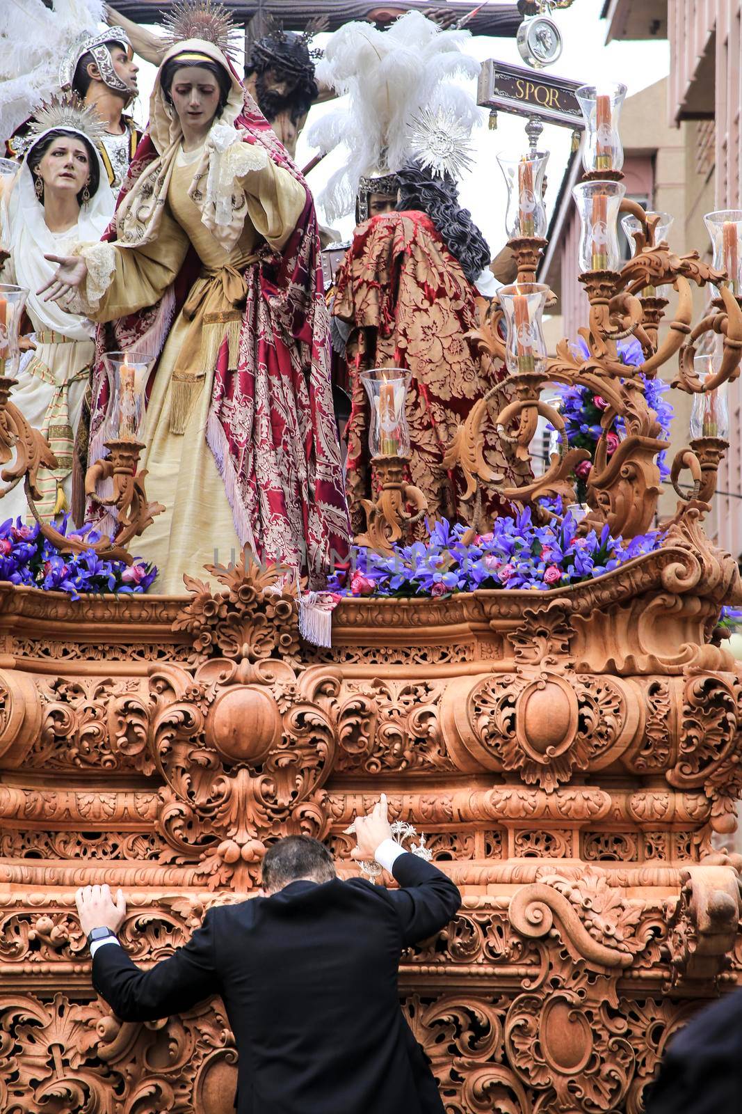 Elche, Spain- April 13, 2022: Easter Parade with bearers and penitents through the streets of Elche city in the Holy Week