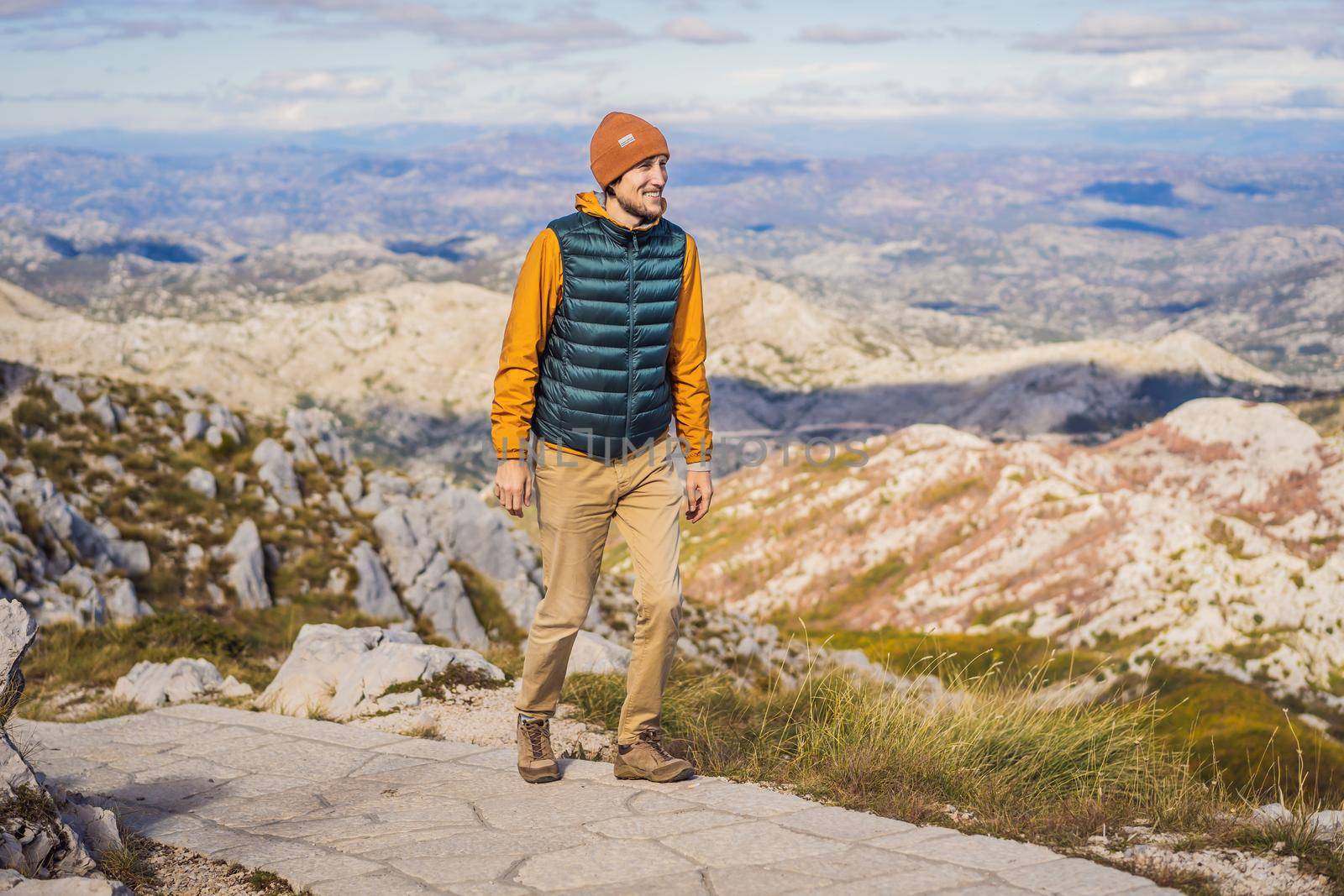 Man traveller in mountain landscape at national park Lovcen, Montenegro. Travel to Montenegro concept.