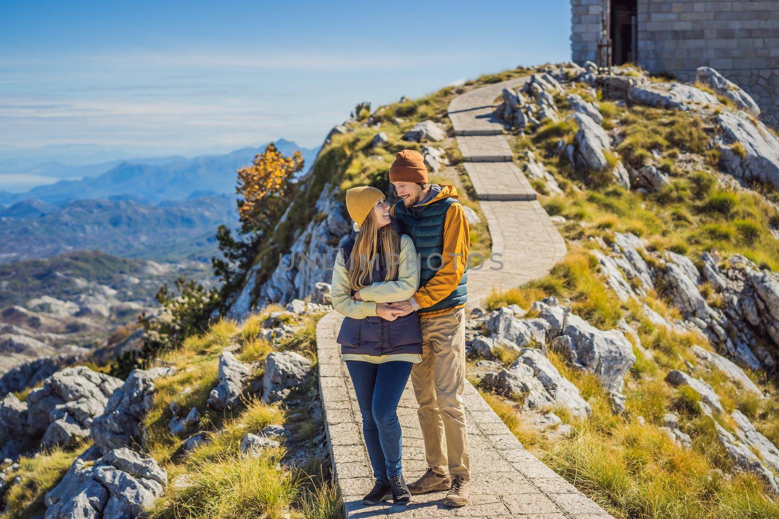 Couple man and woman tourists in mountain landscape at national park Lovcen, Montenegro. Travel to Montenegro concept by galitskaya