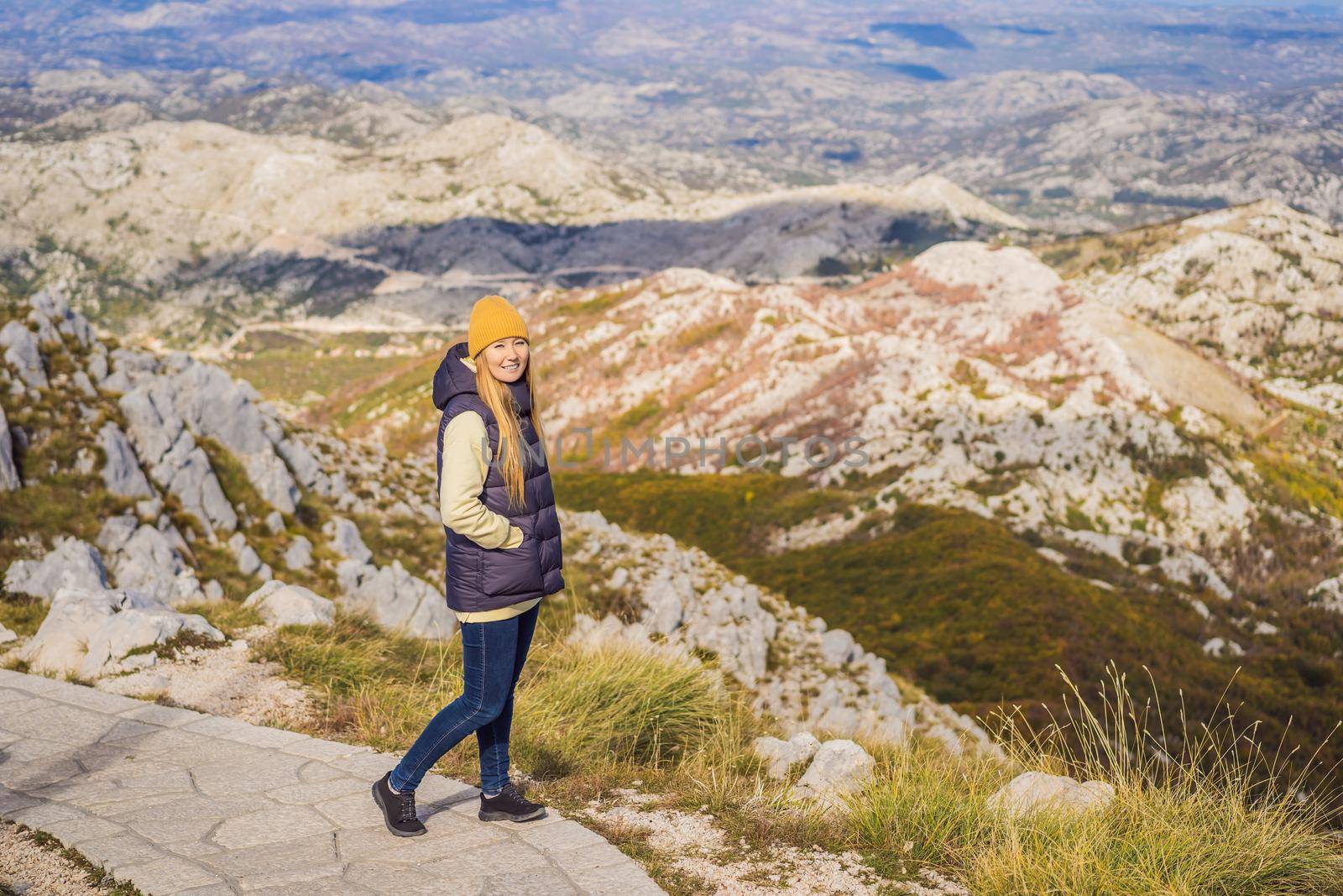 Woman traveller in mountain landscape at national park Lovcen, Montenegro. Travel to Montenegro concept.