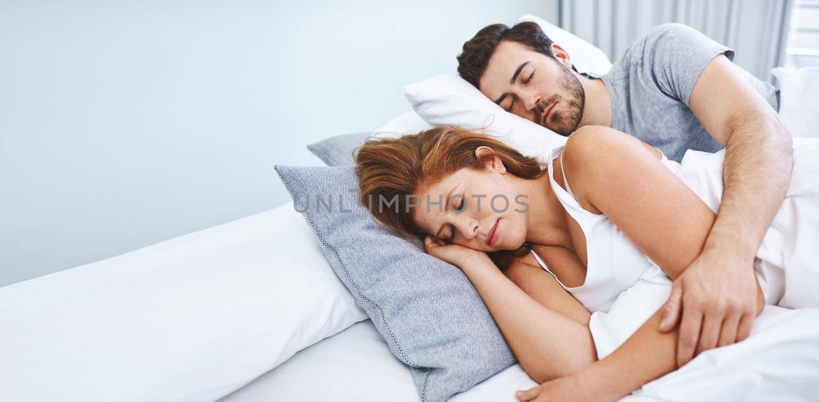 Shot of a couple sleeping in bed together at home.