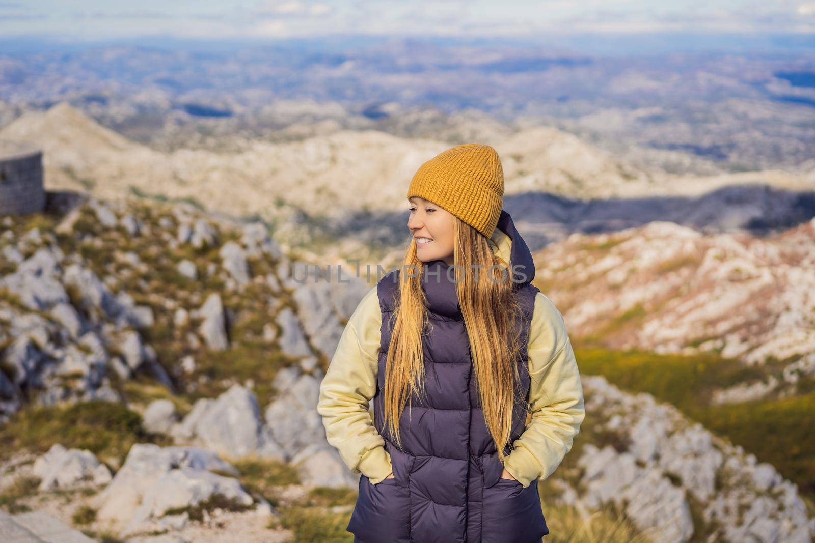 Woman traveller in mountain landscape at national park Lovcen, Montenegro. Travel to Montenegro concept.