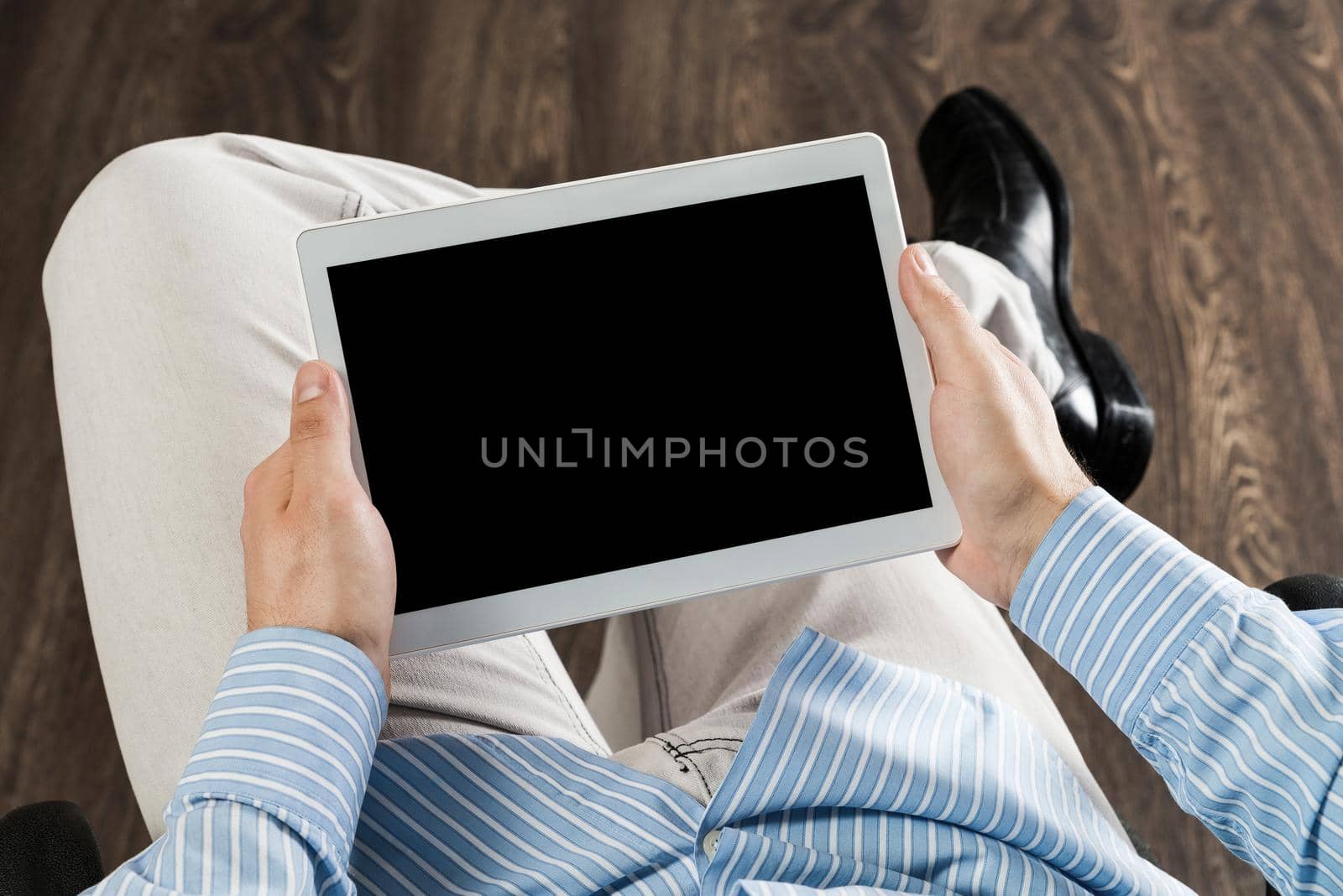 close-up of men's hands with a computer tablet. Businessman works in the office