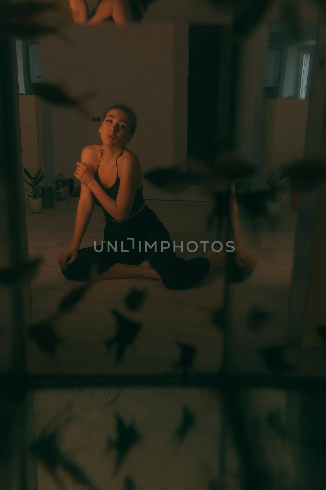 portrait of woman at home during renovation. dark. spot light on the model by Symonenko